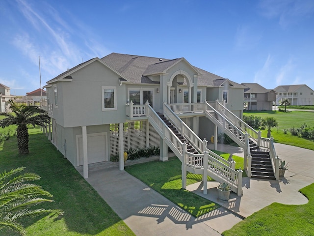 beach home with a garage and a front lawn