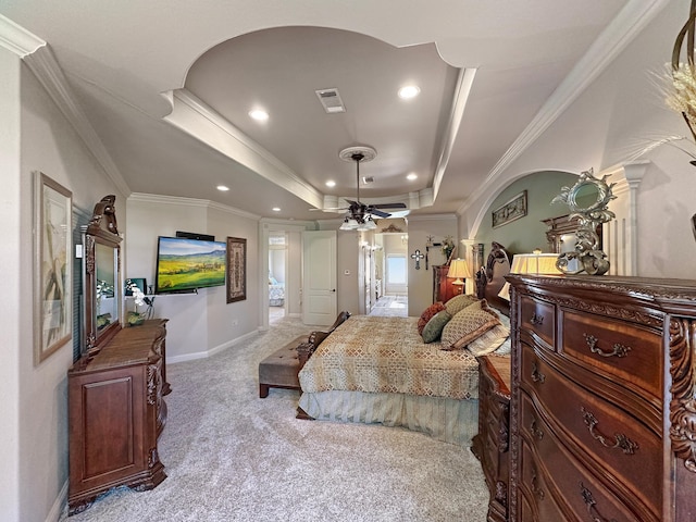 bedroom featuring crown molding, a raised ceiling, and light colored carpet