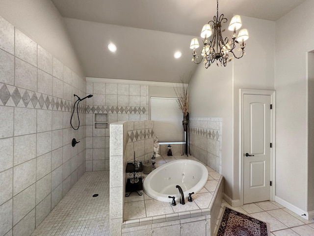 bathroom featuring baseboards, lofted ceiling, a tub with jets, tile patterned floors, and a walk in shower