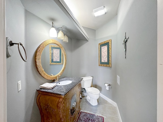 bathroom with vanity, toilet, and tile patterned floors