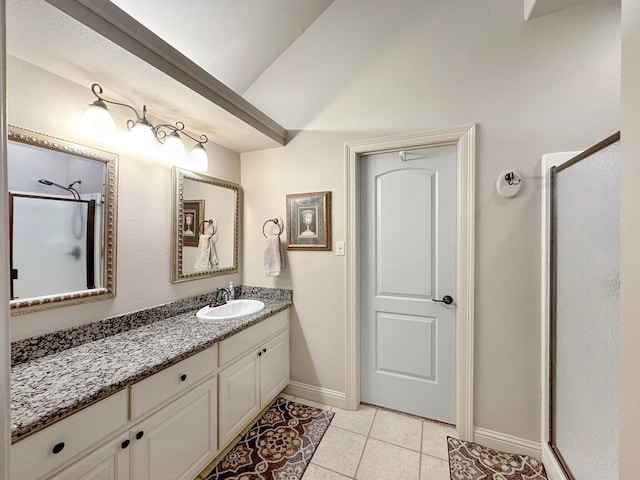 bathroom with a shower with shower door, tile patterned floors, and vanity