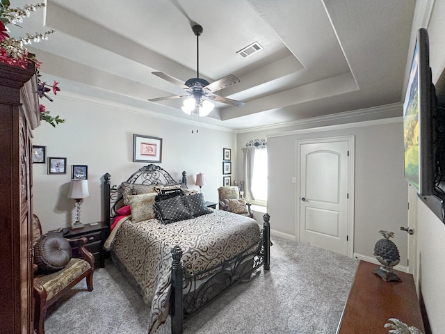 bedroom with crown molding, ceiling fan, and a raised ceiling