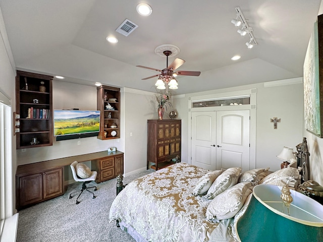 bedroom with carpet floors, rail lighting, and ceiling fan