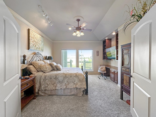 bedroom with carpet flooring, rail lighting, ceiling fan, vaulted ceiling, and ornamental molding