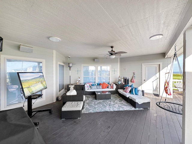 interior space featuring a textured ceiling, ceiling fan, and wood-type flooring