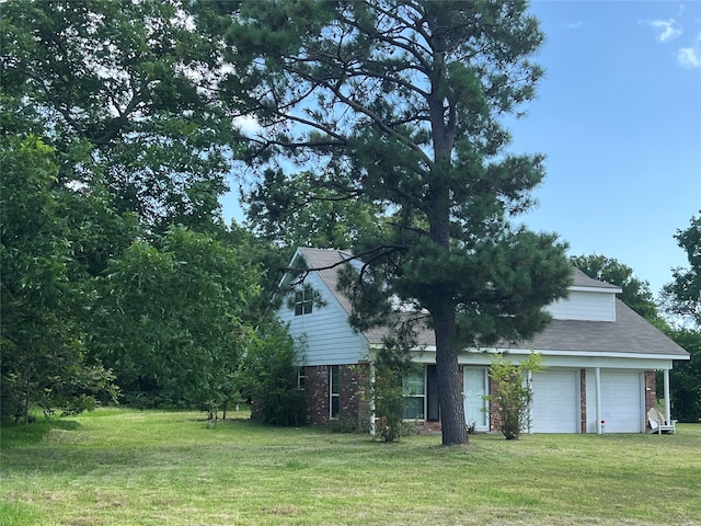 exterior space with a garage and a front lawn