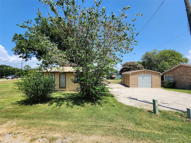 view of front facade with a garage, an outdoor structure, and a front yard