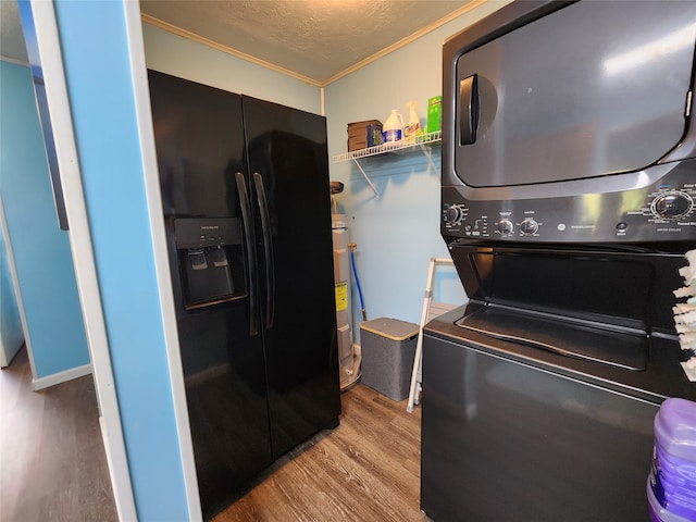 laundry area featuring electric water heater, light hardwood / wood-style floors, stacked washer / drying machine, and ornamental molding