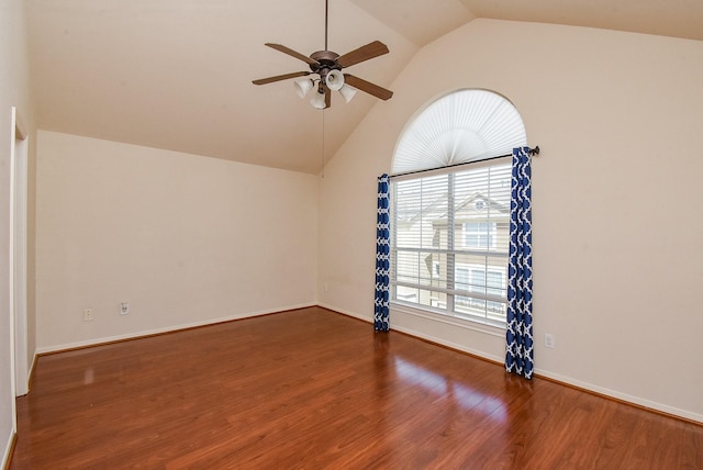 spare room with high vaulted ceiling, dark hardwood / wood-style floors, and ceiling fan