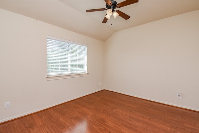 empty room with wood-type flooring, ceiling fan, and vaulted ceiling