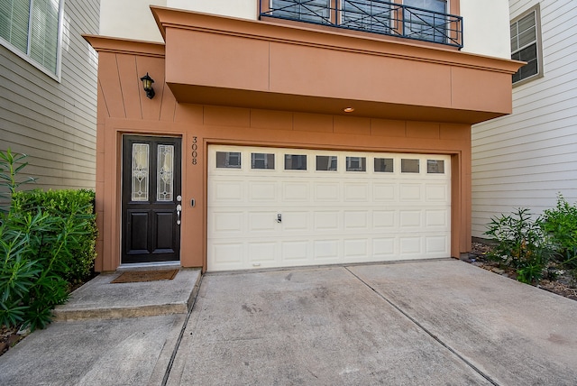 view of exterior entry with a balcony