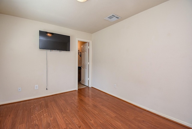 spare room featuring wood-type flooring