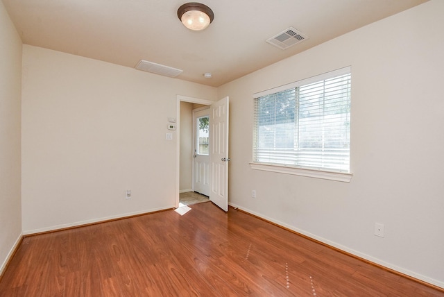 empty room with wood-type flooring