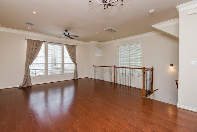 empty room featuring crown molding, dark hardwood / wood-style floors, and ceiling fan