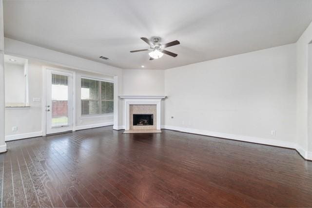 unfurnished living room with ceiling fan and dark hardwood / wood-style floors