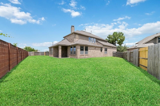 back of property featuring a lawn