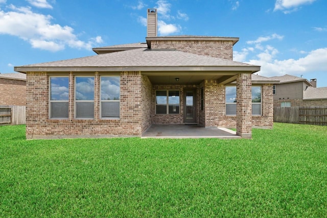 rear view of property featuring a patio area and a yard