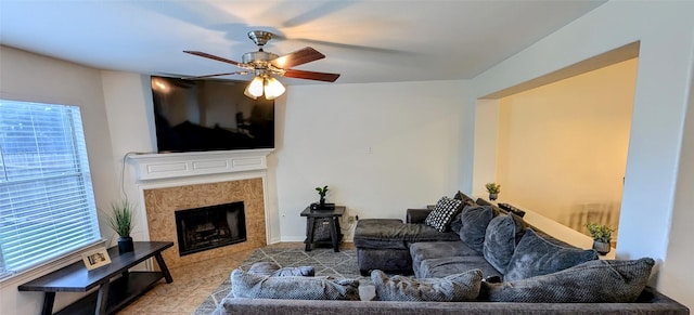 living room featuring ceiling fan, a wealth of natural light, and a high end fireplace