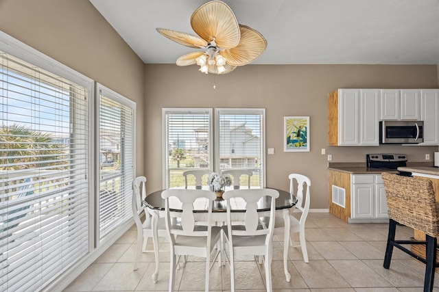 tiled dining room featuring ceiling fan