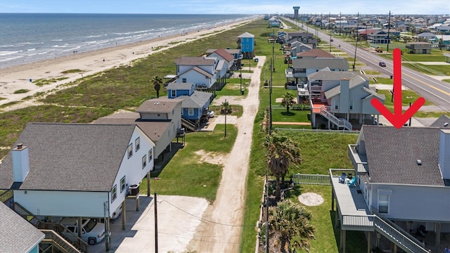 aerial view with a water view and a beach view