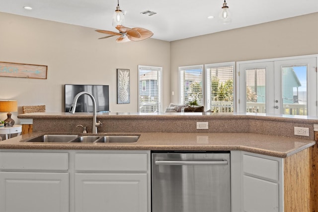 kitchen featuring white cabinets, stainless steel dishwasher, ceiling fan, and sink