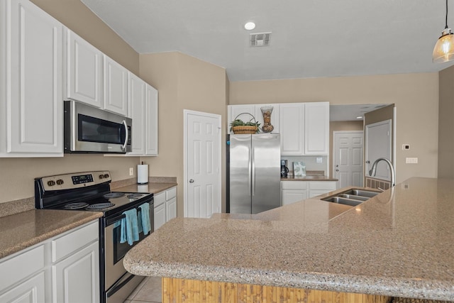 kitchen with white cabinets, sink, hanging light fixtures, light stone countertops, and stainless steel appliances