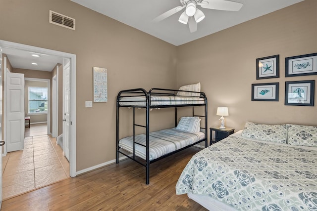 bedroom with ceiling fan and hardwood / wood-style flooring