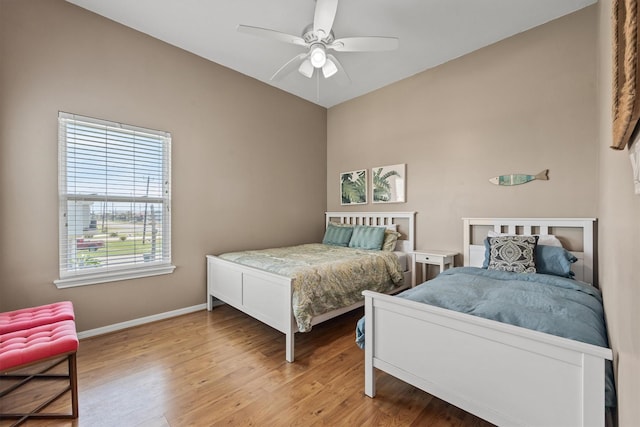 bedroom with light hardwood / wood-style floors and ceiling fan