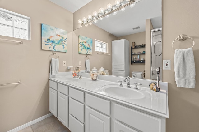 bathroom featuring tile patterned flooring, vanity, and toilet