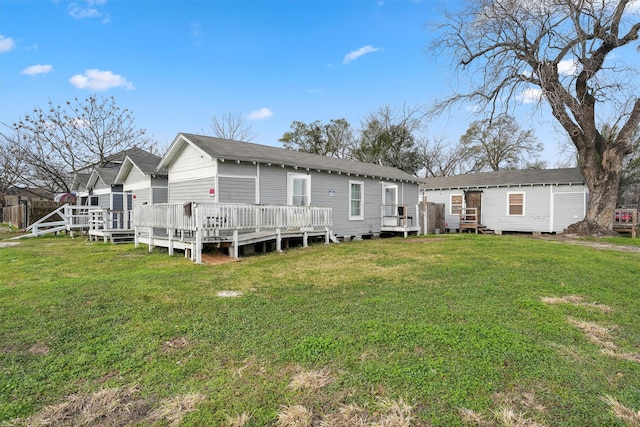 back of house featuring a deck and a yard