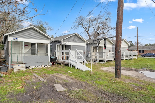 view of front facade featuring a deck and a front yard