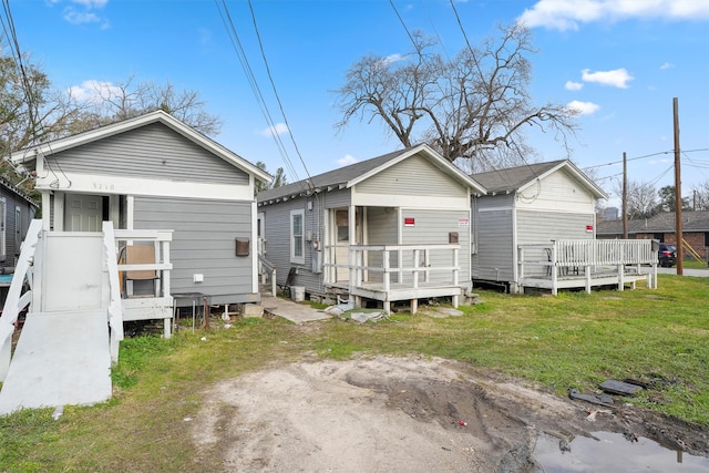 back of property featuring a lawn