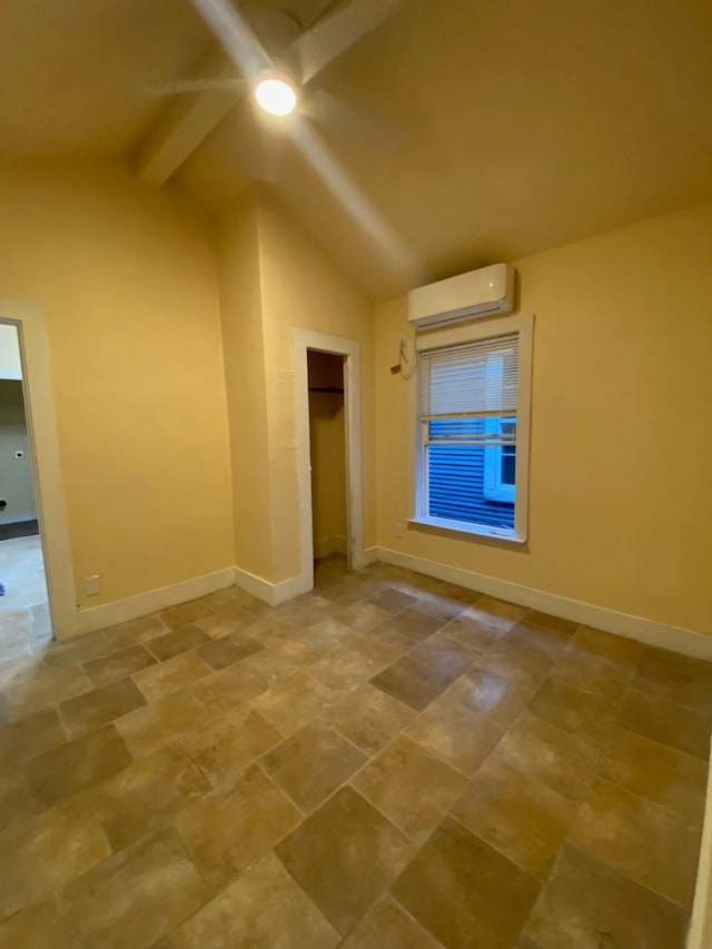 interior space with tile patterned flooring, an AC wall unit, lofted ceiling with beams, and ceiling fan