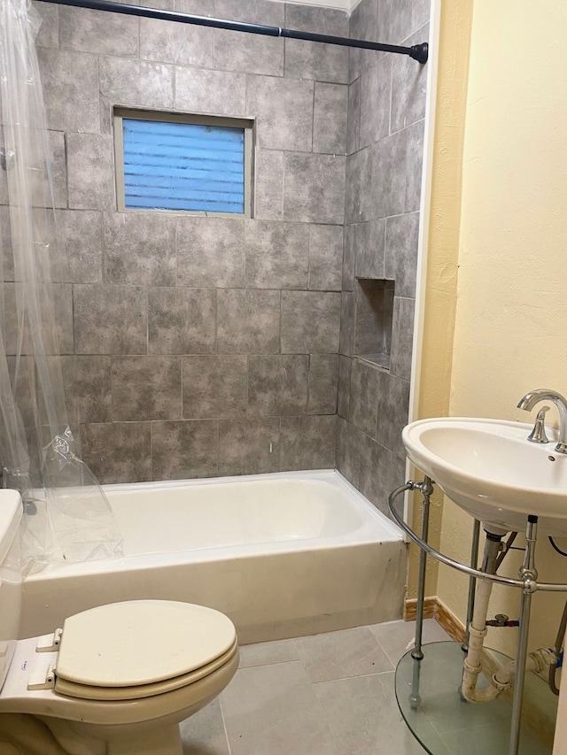 bathroom featuring shower / bath combo with shower curtain, tile patterned floors, and toilet