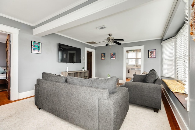 living room featuring hardwood / wood-style flooring, ceiling fan, and ornamental molding