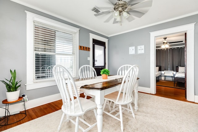 dining area featuring crown molding, hardwood / wood-style floors, and ceiling fan