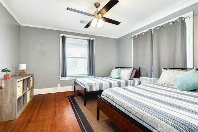 bedroom featuring crown molding, ceiling fan, and dark hardwood / wood-style flooring