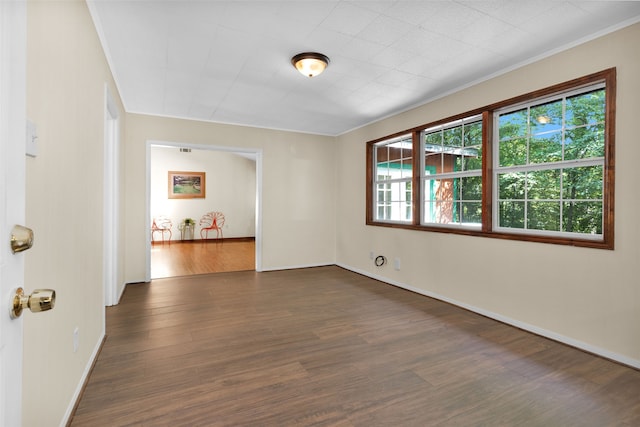 unfurnished room with crown molding and dark hardwood / wood-style floors