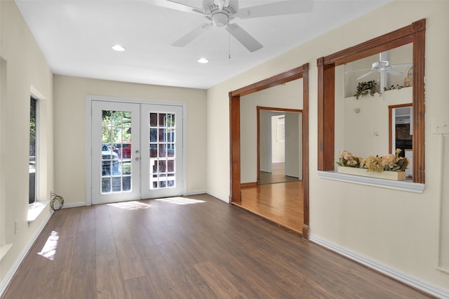 empty room with french doors, ceiling fan, and dark hardwood / wood-style flooring