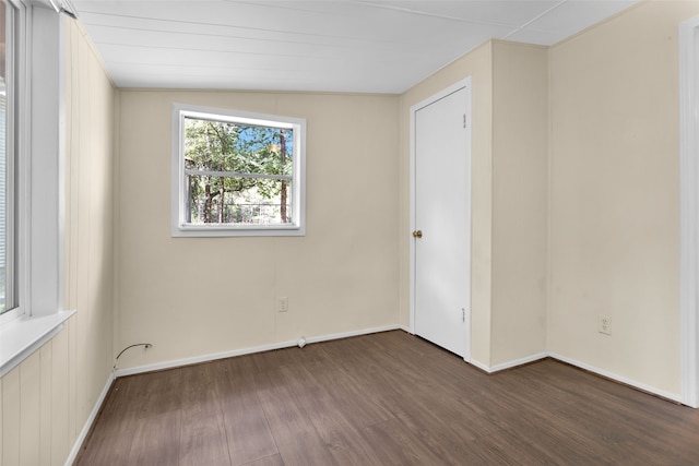 unfurnished room featuring vaulted ceiling and dark hardwood / wood-style floors