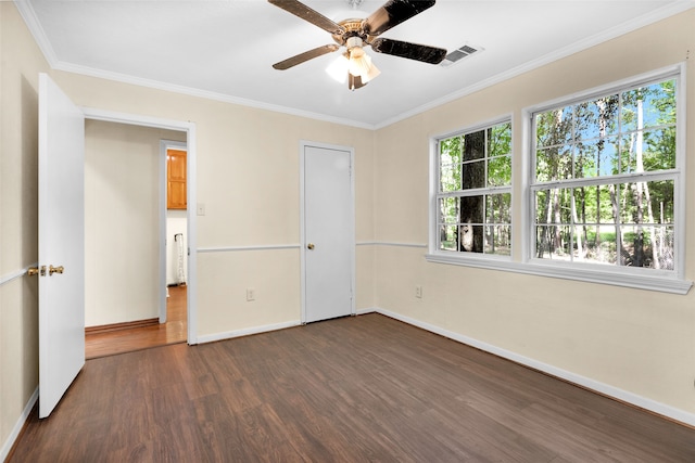 unfurnished bedroom with crown molding, dark hardwood / wood-style floors, a closet, and ceiling fan