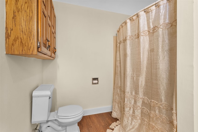 bathroom with toilet and wood-type flooring