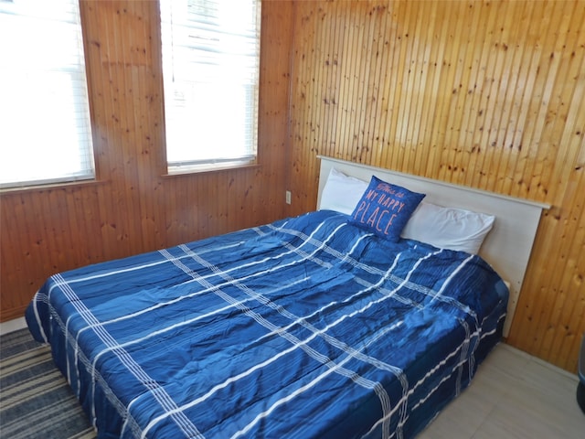 bedroom with wood walls