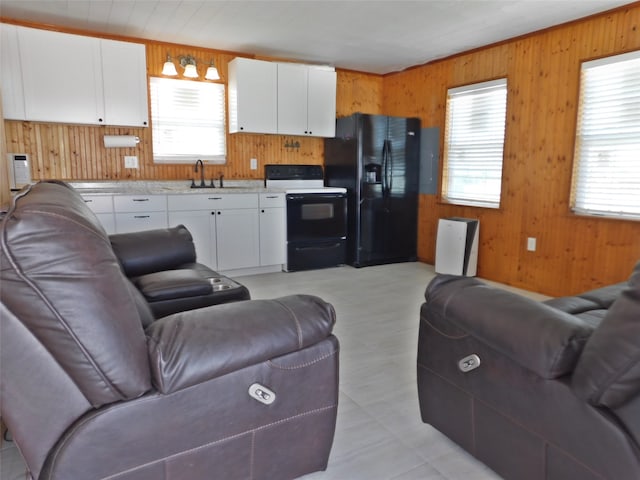 living room with wood walls and sink