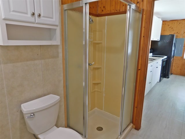 bathroom featuring vanity, an enclosed shower, tile patterned flooring, and toilet