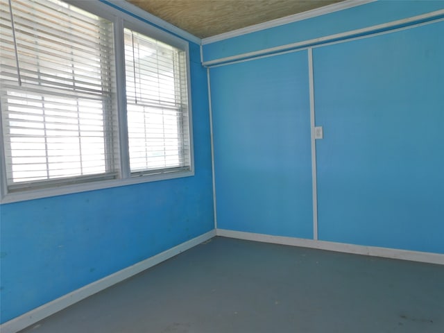 unfurnished room featuring concrete flooring and a wealth of natural light