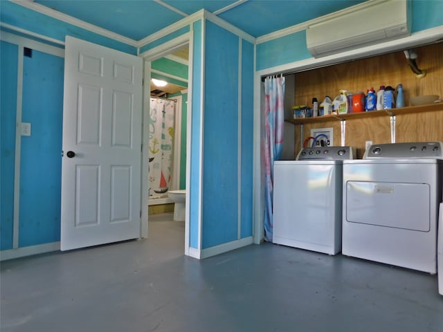 washroom featuring a wall mounted air conditioner and washer and dryer