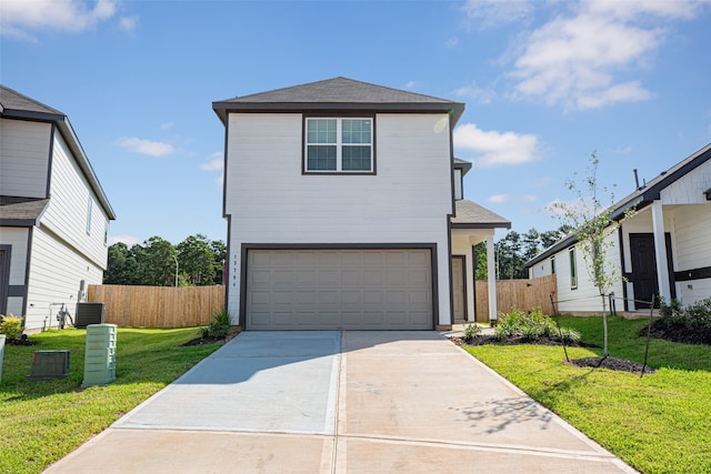 view of front property featuring a front yard and a garage