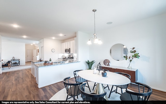 dining room with a notable chandelier and hardwood / wood-style floors