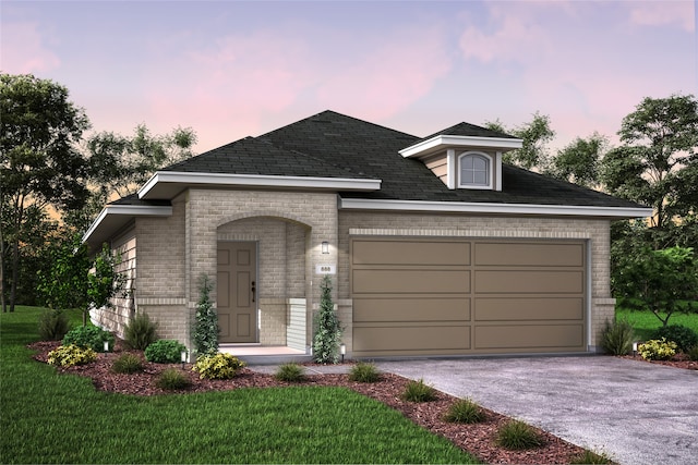 view of front of property with a garage and a lawn